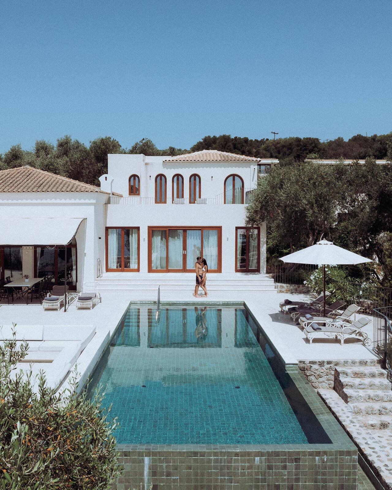 Luxury villa with pool on a sunny day — illustrative property style — illustrative style for Caldera Light Suites