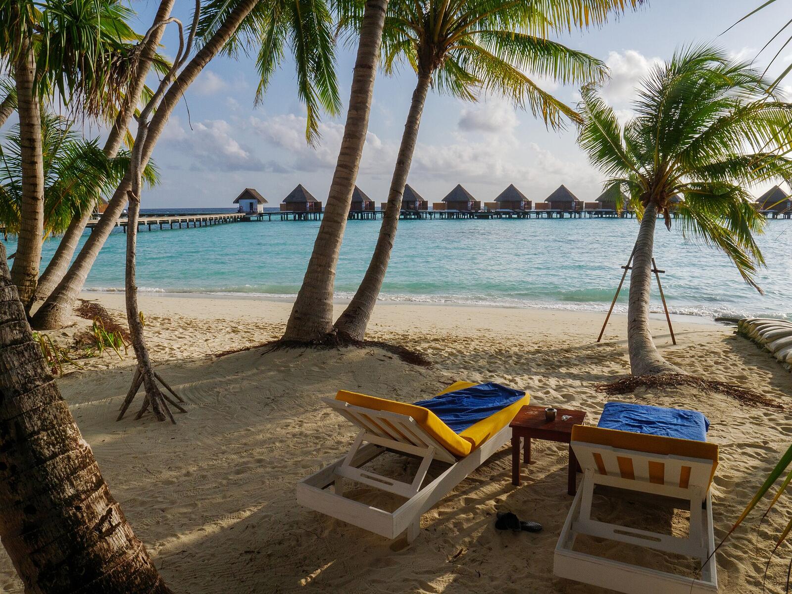 Illustrative accommodation photography for a fictional maldives stay — illustrative style for Palm & Pearl Hideaway