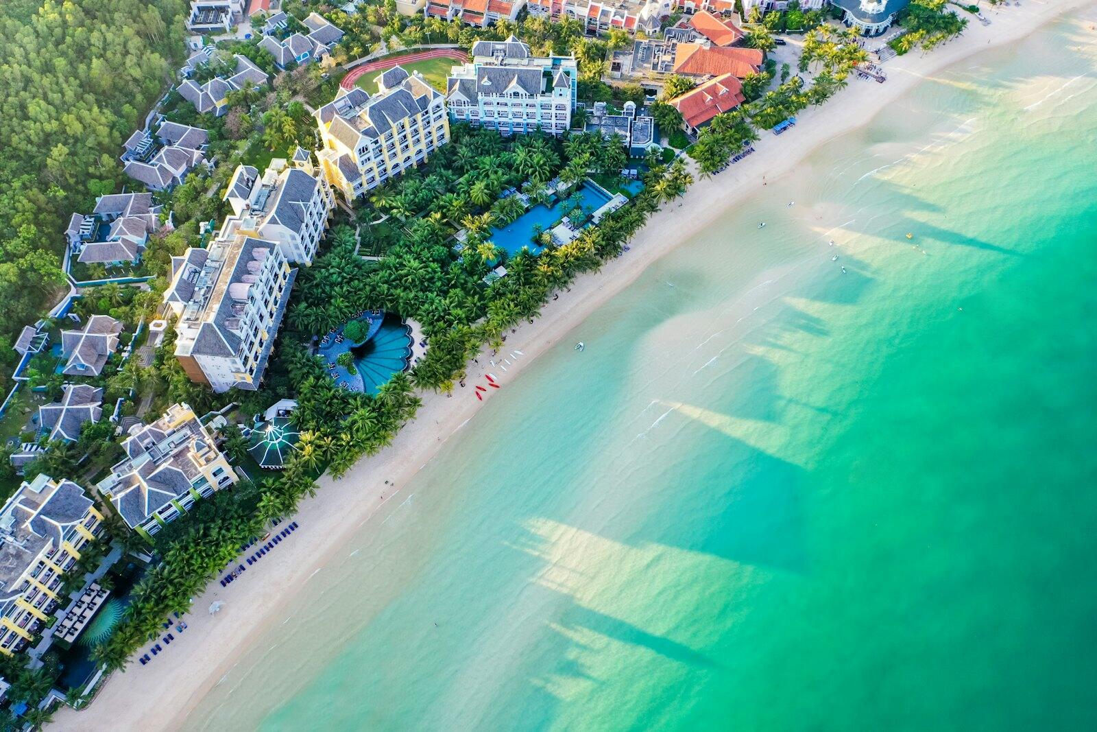 A bird's eye view of a resort on the beach — illustrative property style — illustrative style for Mekong Palm Lodge