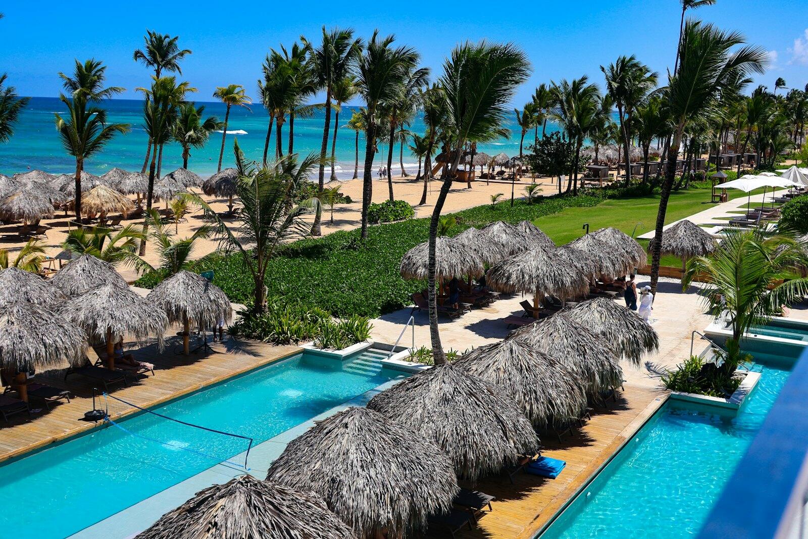 Tropical resort with pools and ocean view — illustrative property style — illustrative style for Palm Cove Villas