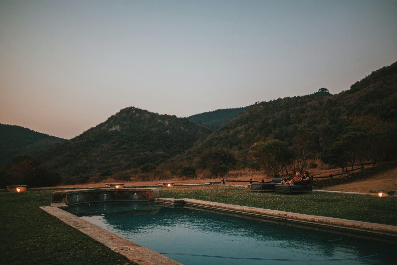 a swimming pool in the middle of a field — illustrative property style — illustrative style for Hermanus Coastal Villas