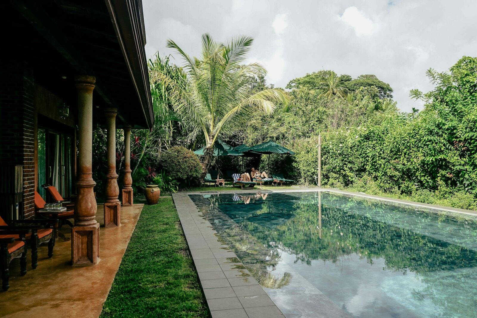 A long pool with chairs and an umbrella next to it — illustrative property style — illustrative style for Tea Ridge House