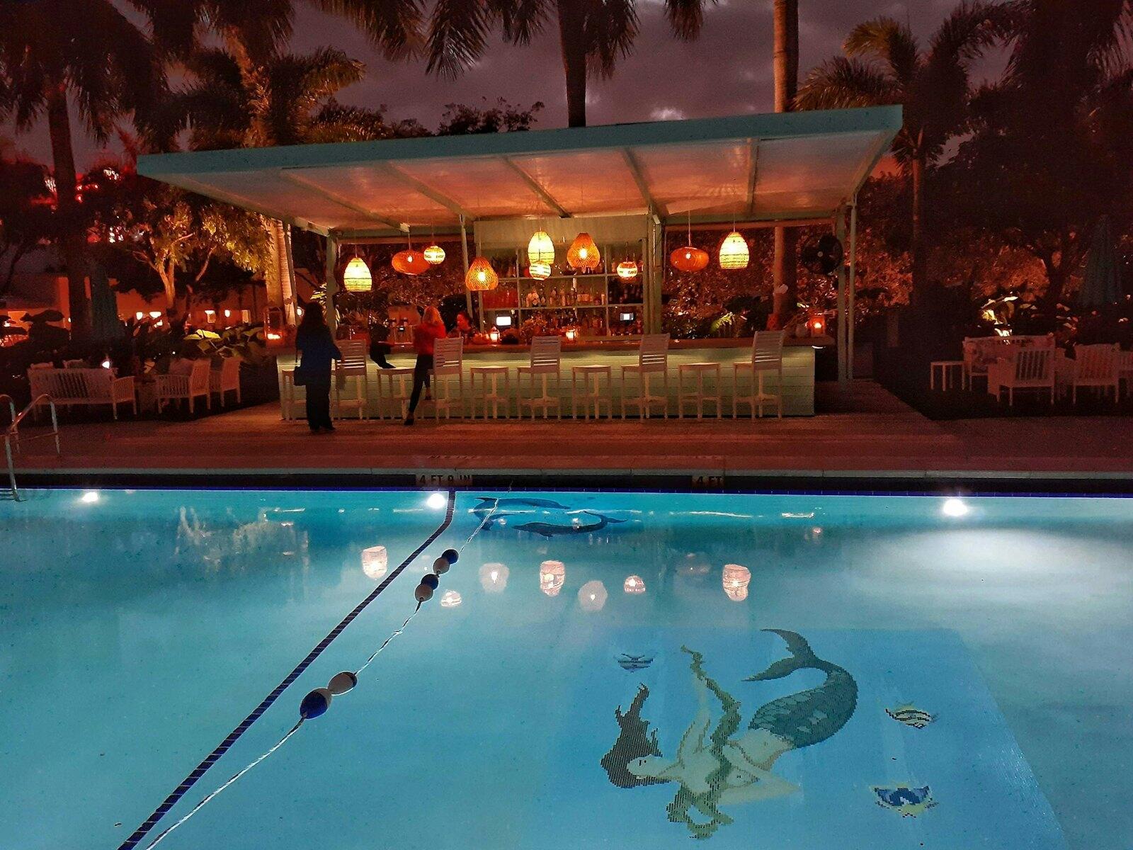 a large swimming pool with a bar in the background — illustrative property style — illustrative style for Santa Fe Courtyard Inn