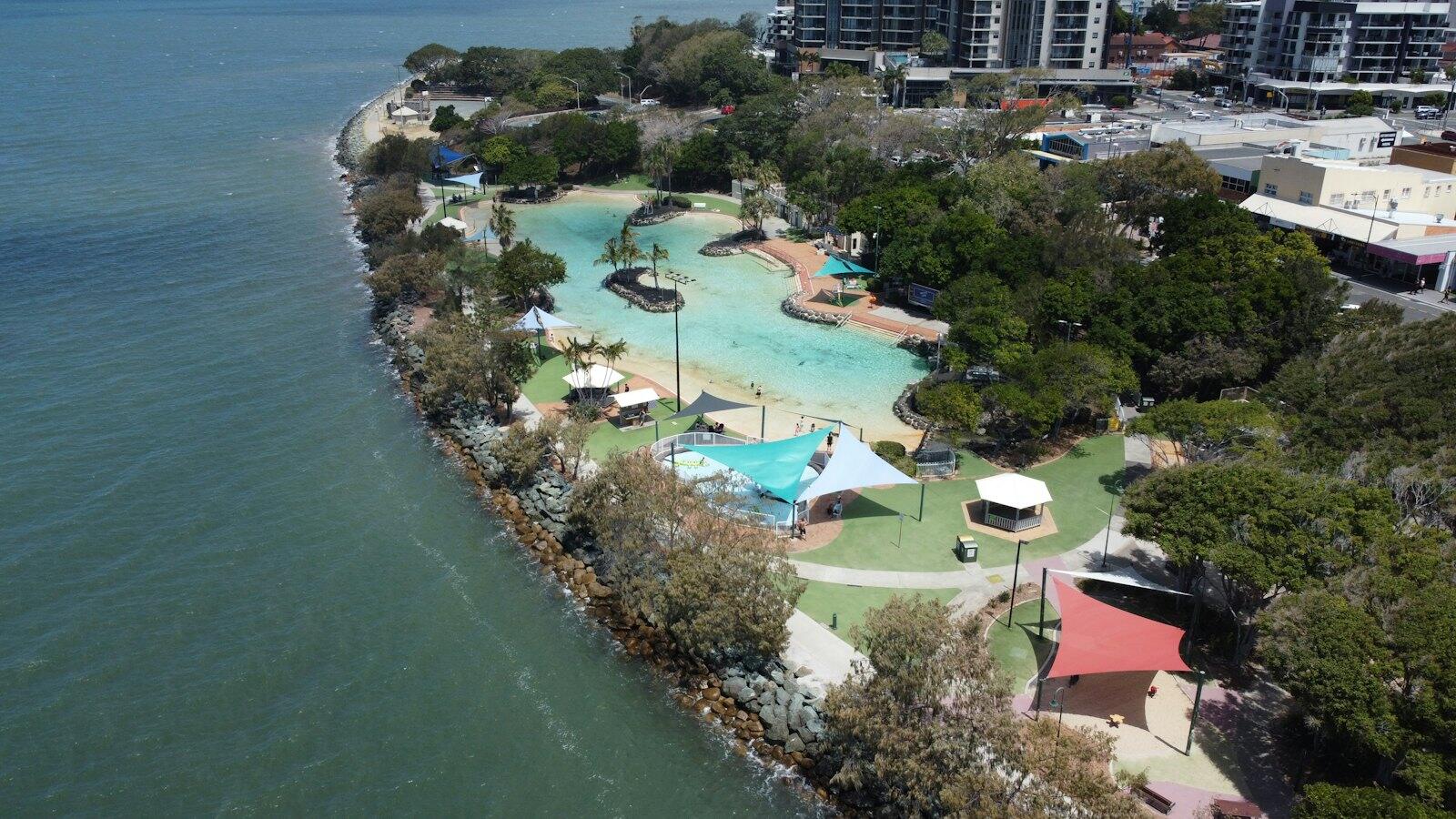an aerial view of a resort with a swimming pool — illustrative property style — illustrative style for Coral Coast Villas