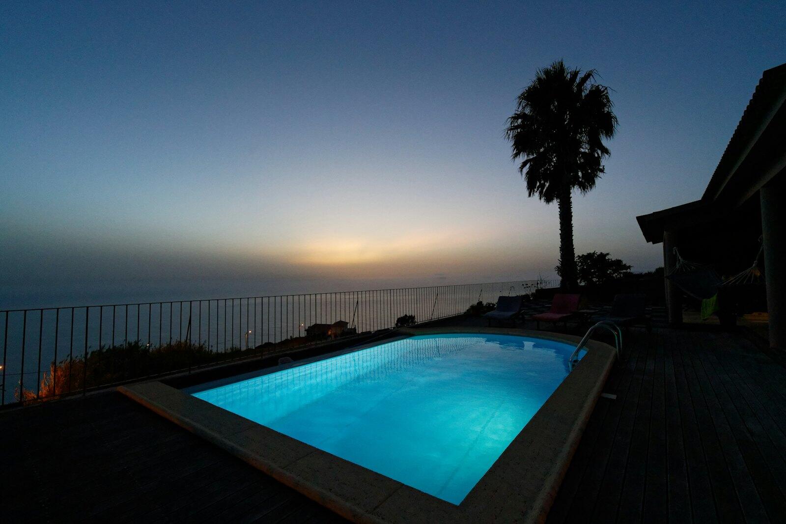 swimming pool near palm trees during sunset — illustrative property style — illustrative style for Madeira Garden Retreat