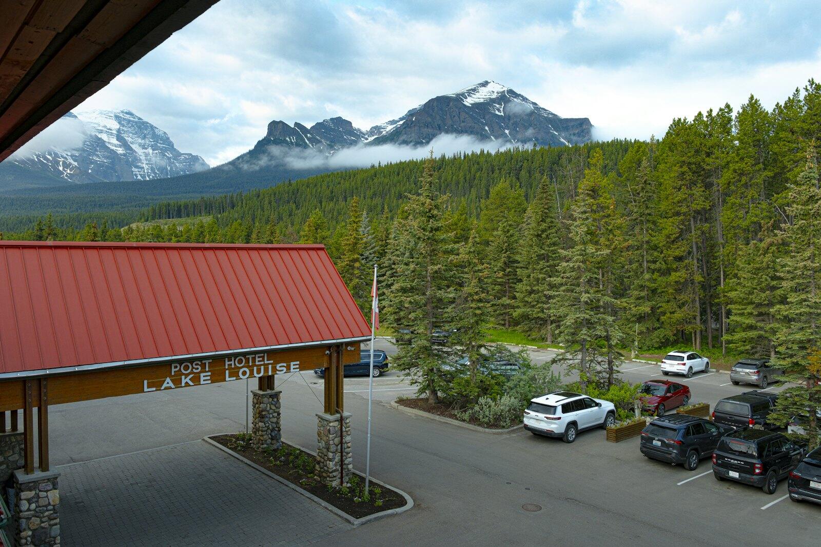 Hotel entrance with mountain and forest backdrop — illustrative property style — illustrative style for Niagara Orchard Retreat