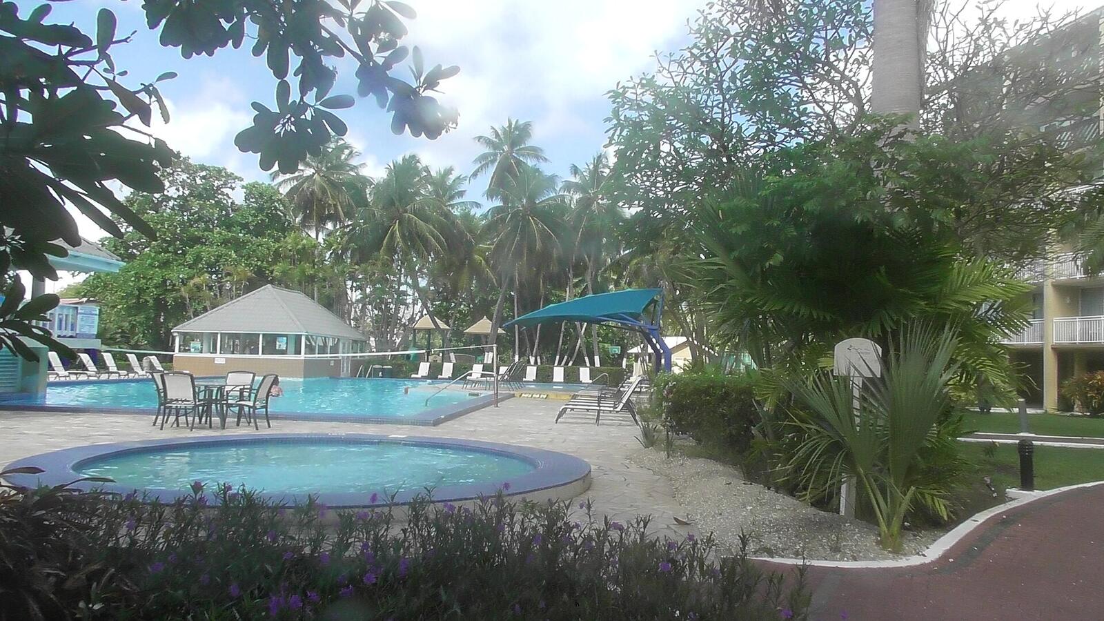 Illustrative accommodation photography for a fictional barbados stay — illustrative style for Seafoam Terrace Suites