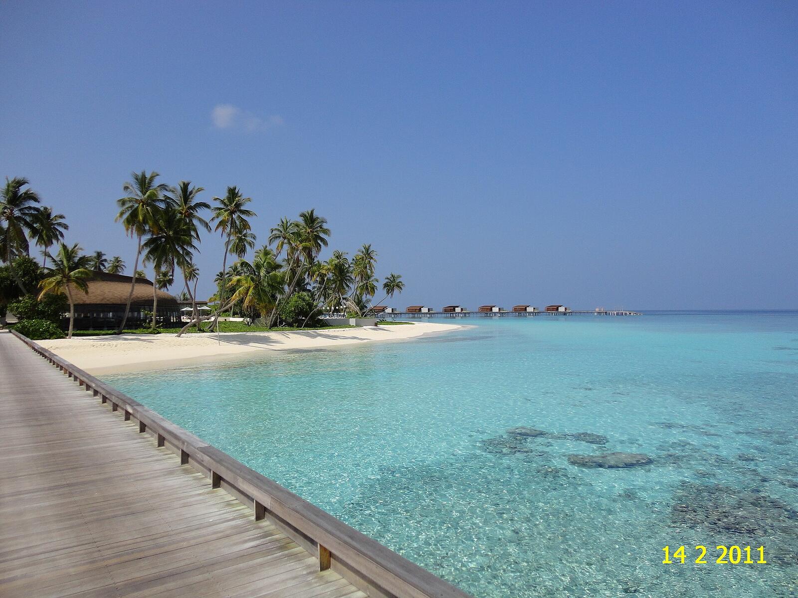 Illustrative accommodation photography for a fictional maldives stay — illustrative style for Coral Ember Island