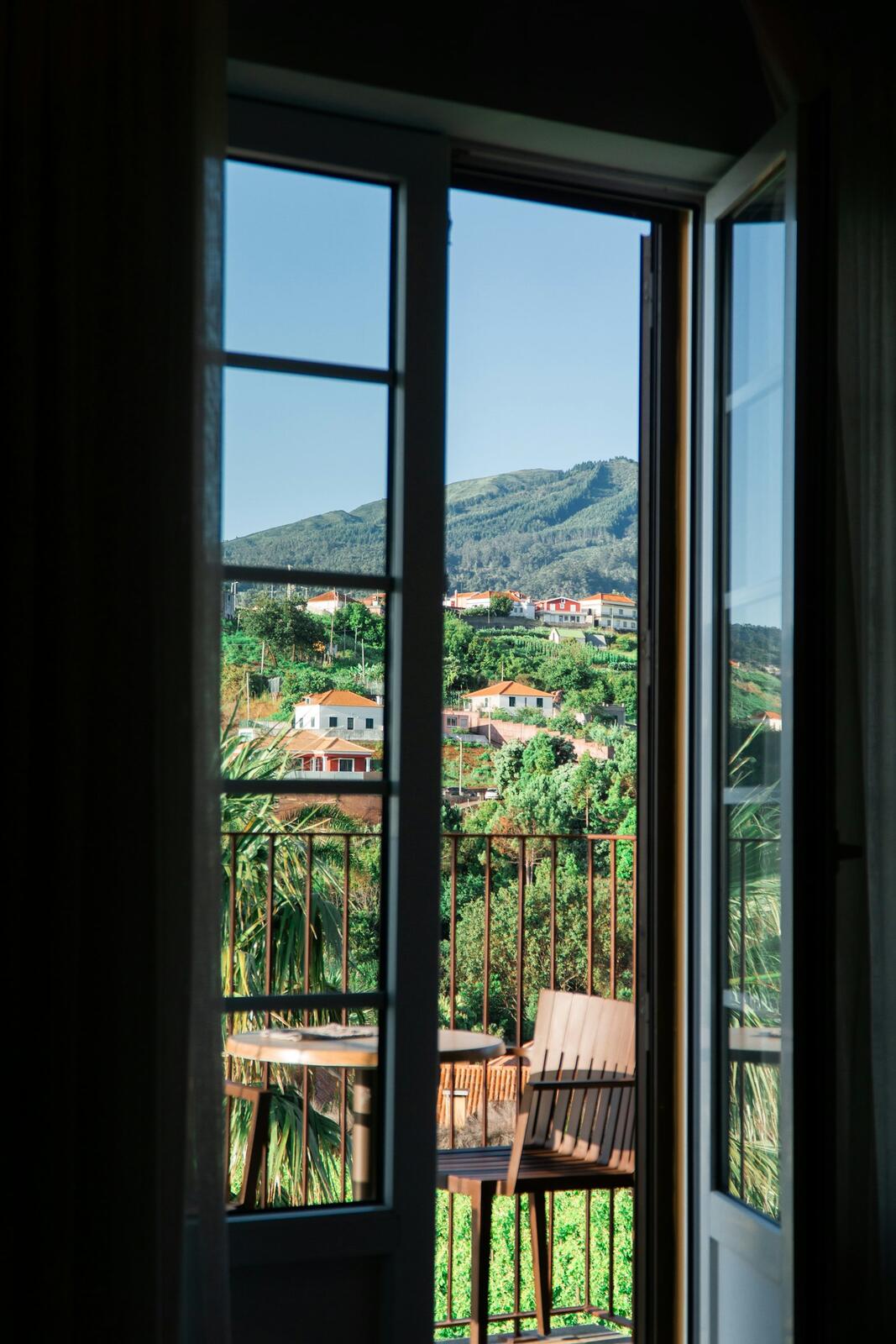 View of village on a green hillside through open doors — illustrative property style — illustrative style for Algarve Palm Villas