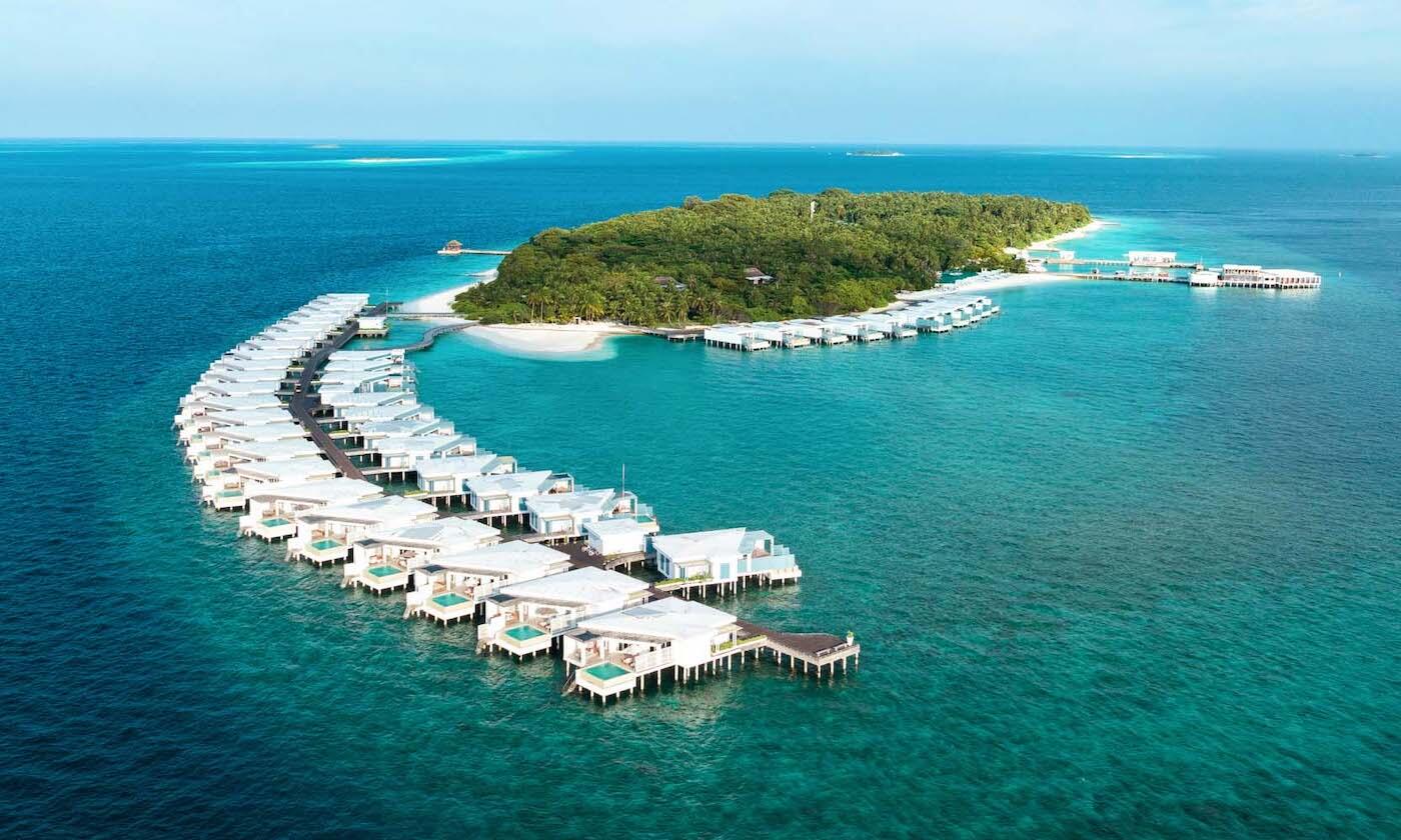Illustrative accommodation photography for a fictional maldives stay — illustrative style for Pearlwater Lagoon Villas