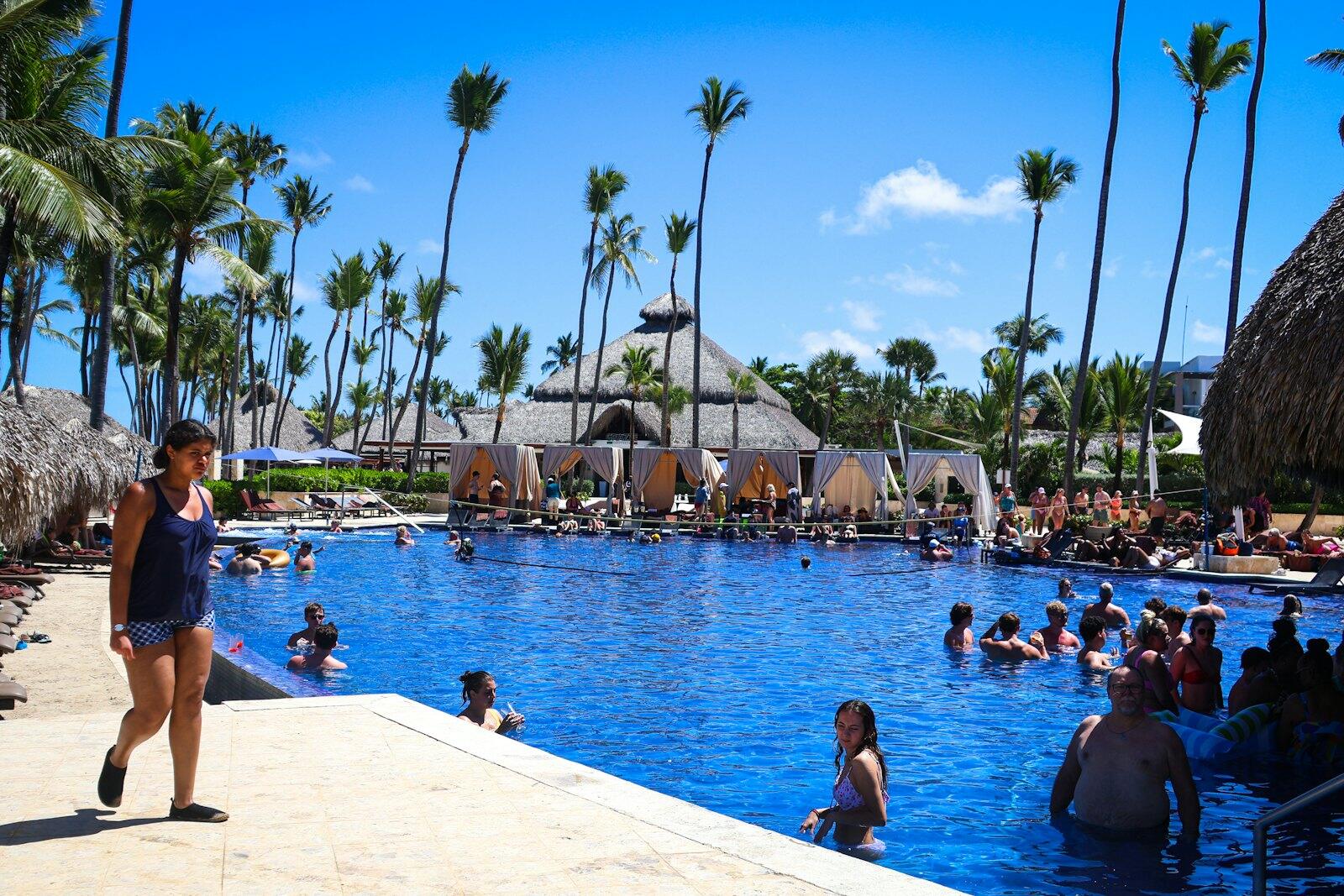 People enjoy the pool at a tropical resort — illustrative property style — illustrative style for Piton View House