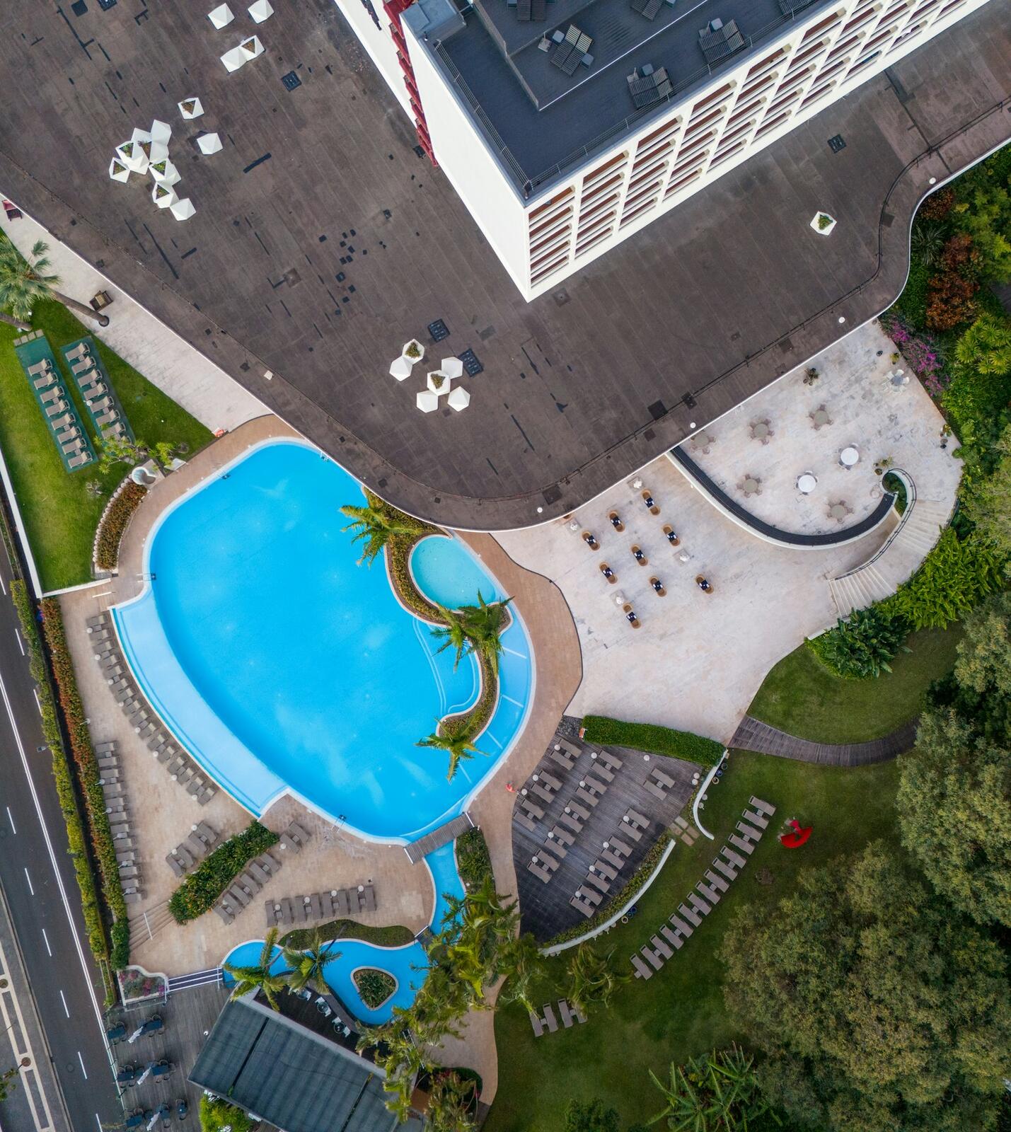 Aerial view of a resort pool and building — illustrative property style — illustrative style for Porto River Rooms