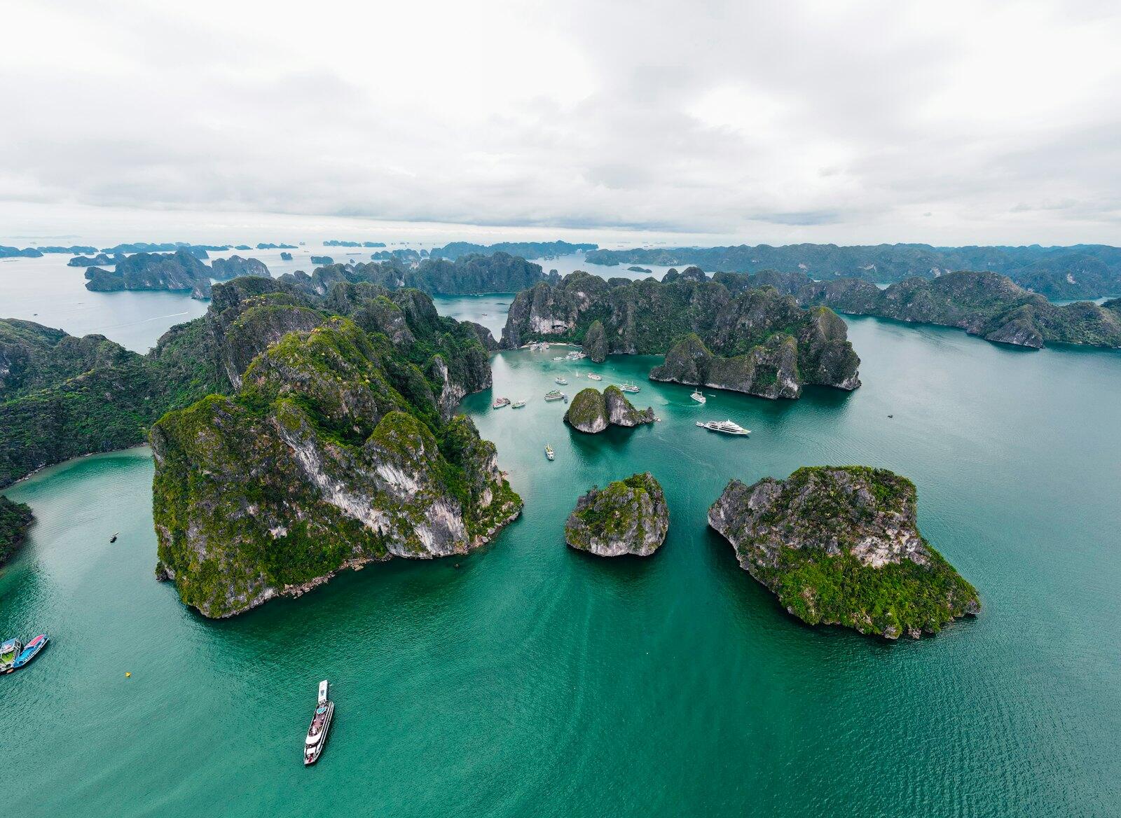 Limestone islands rising from turquoise water in Vietnam