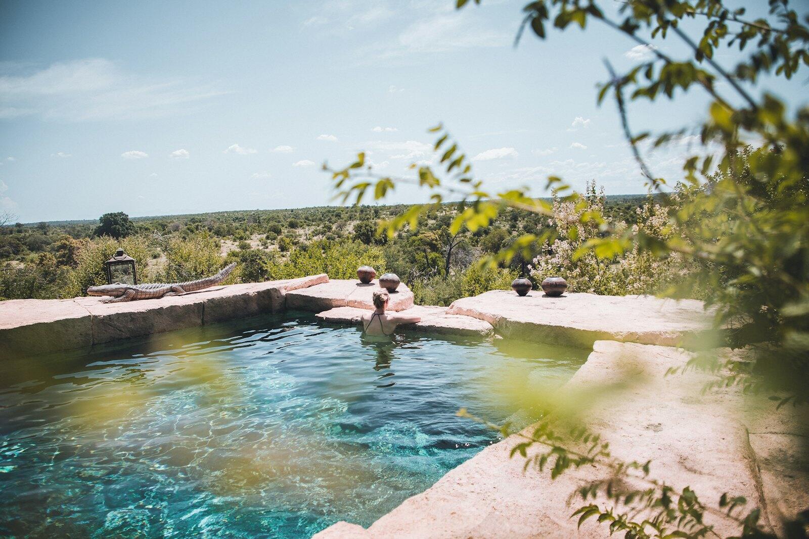 man and woman in swimming pool during daytime — illustrative property style — illustrative style for Knysna Lagoon Residence
