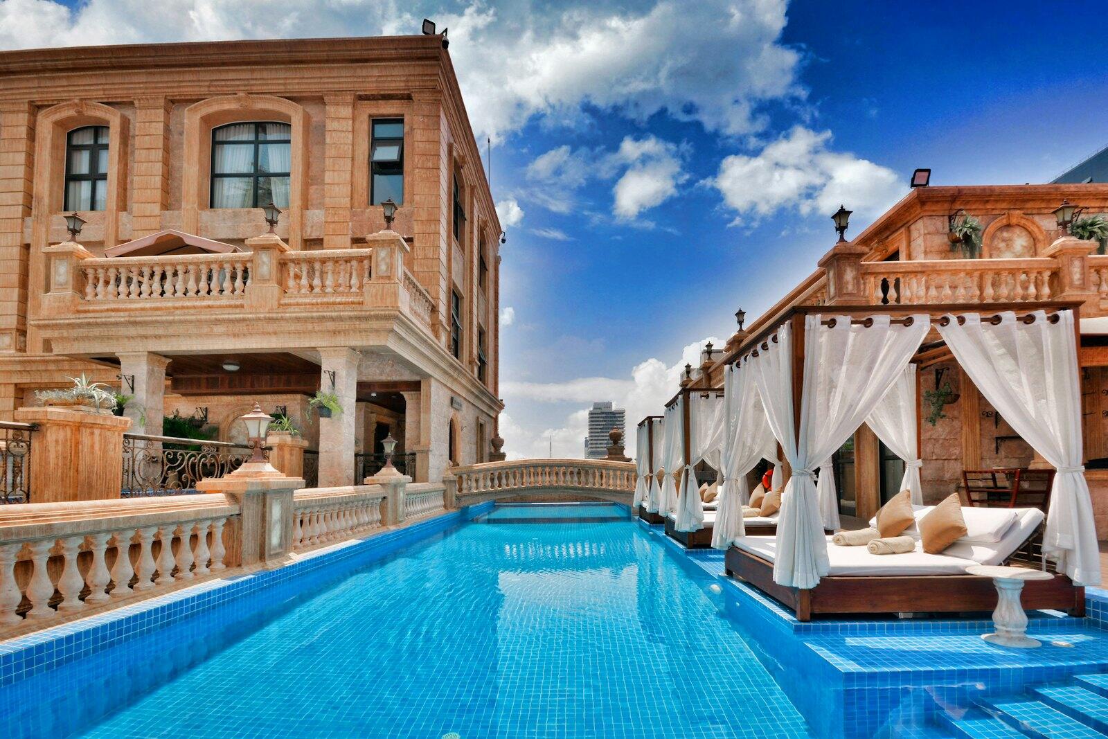 A pool and a house — illustrative property style — illustrative style for Kampot Pepper Retreat