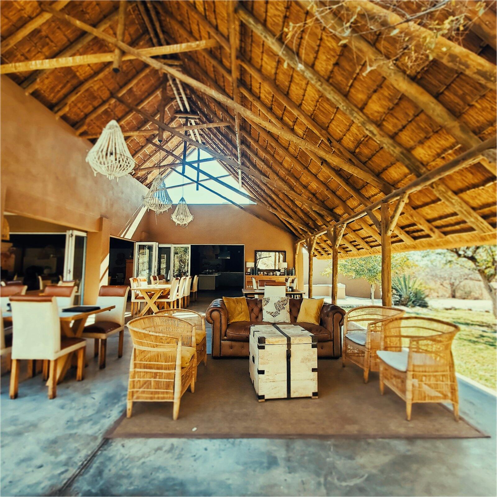 Open-air safari lodge with thatched roof — illustrative property style — illustrative style for Laikipia Horizon Lodge