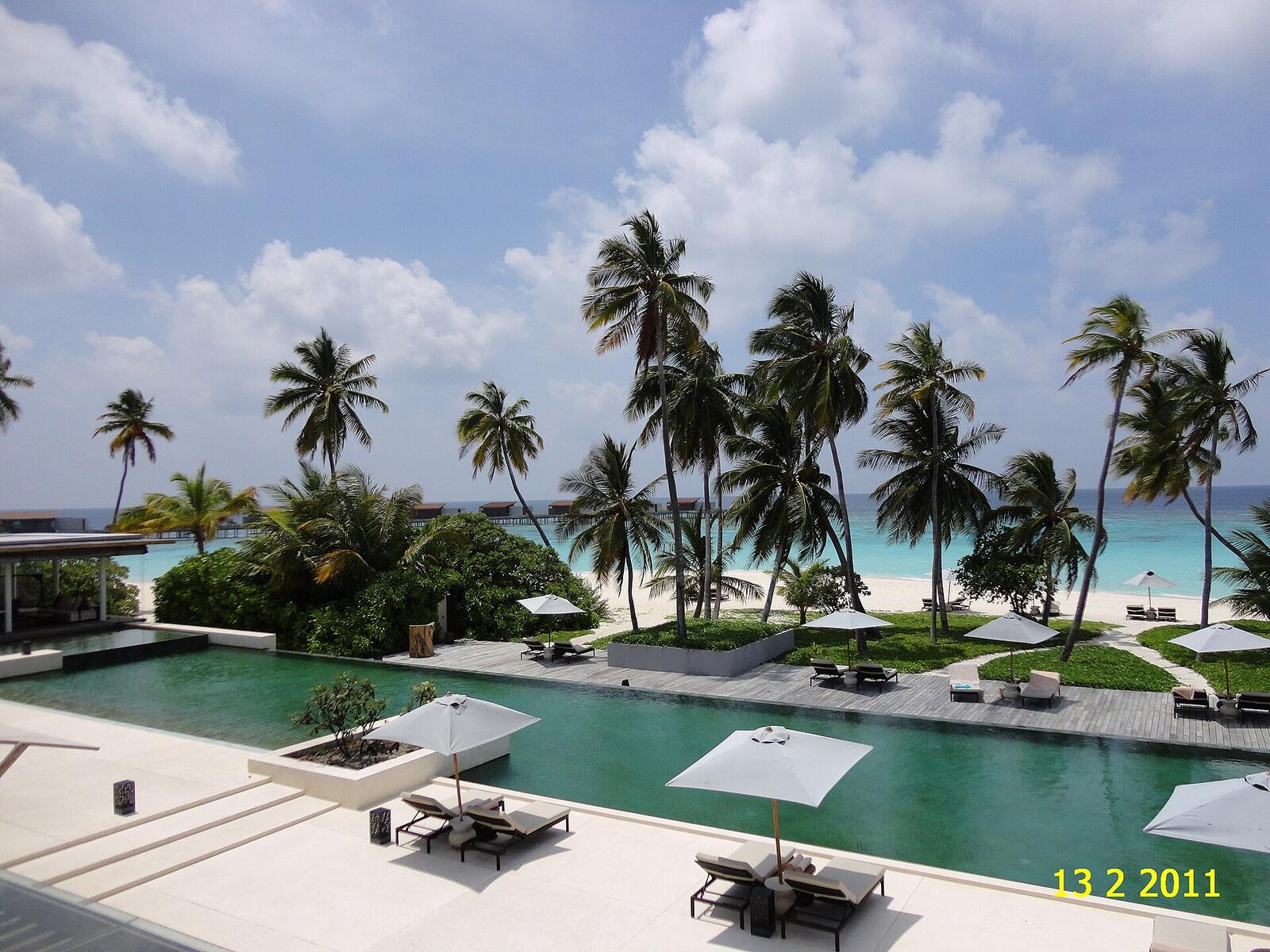 Illustrative accommodation photography for a fictional maldives stay — illustrative style for Nautilus Garden Retreat