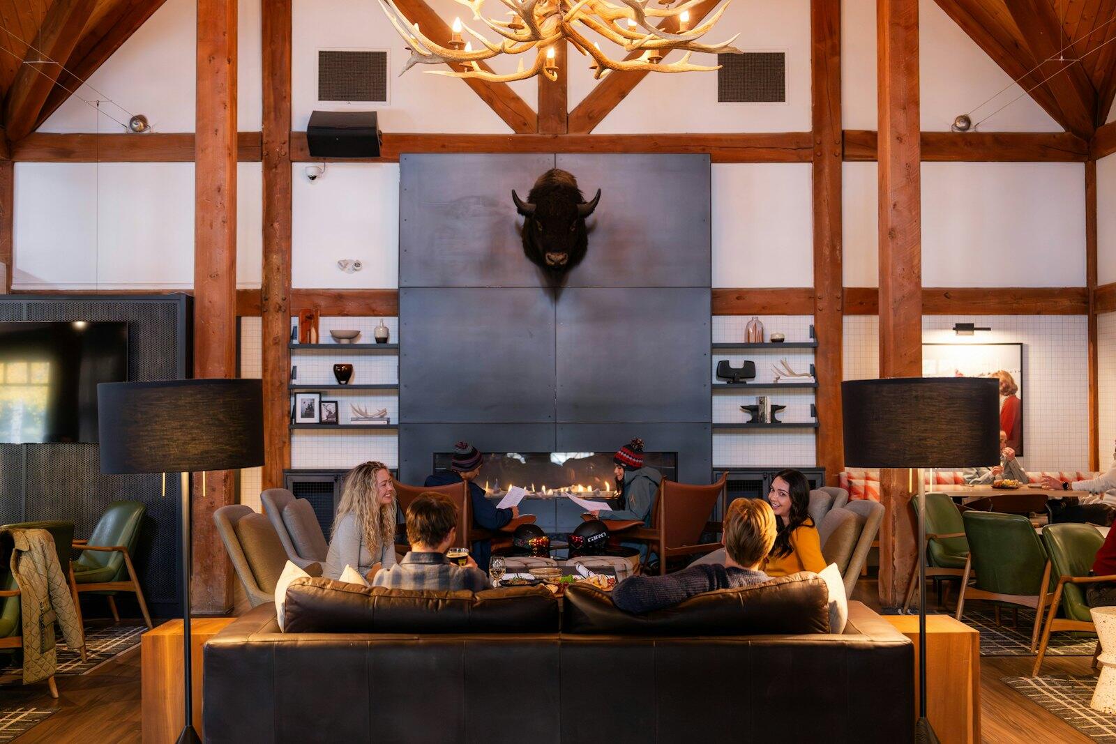People relax in a cozy lodge with a large fireplace — illustrative property style — illustrative style for Quebec Family Residence