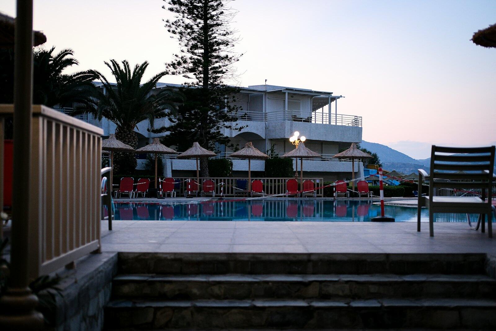 A view of a swimming pool from a deck — illustrative property style — illustrative style for Olive Grove Family Retreat