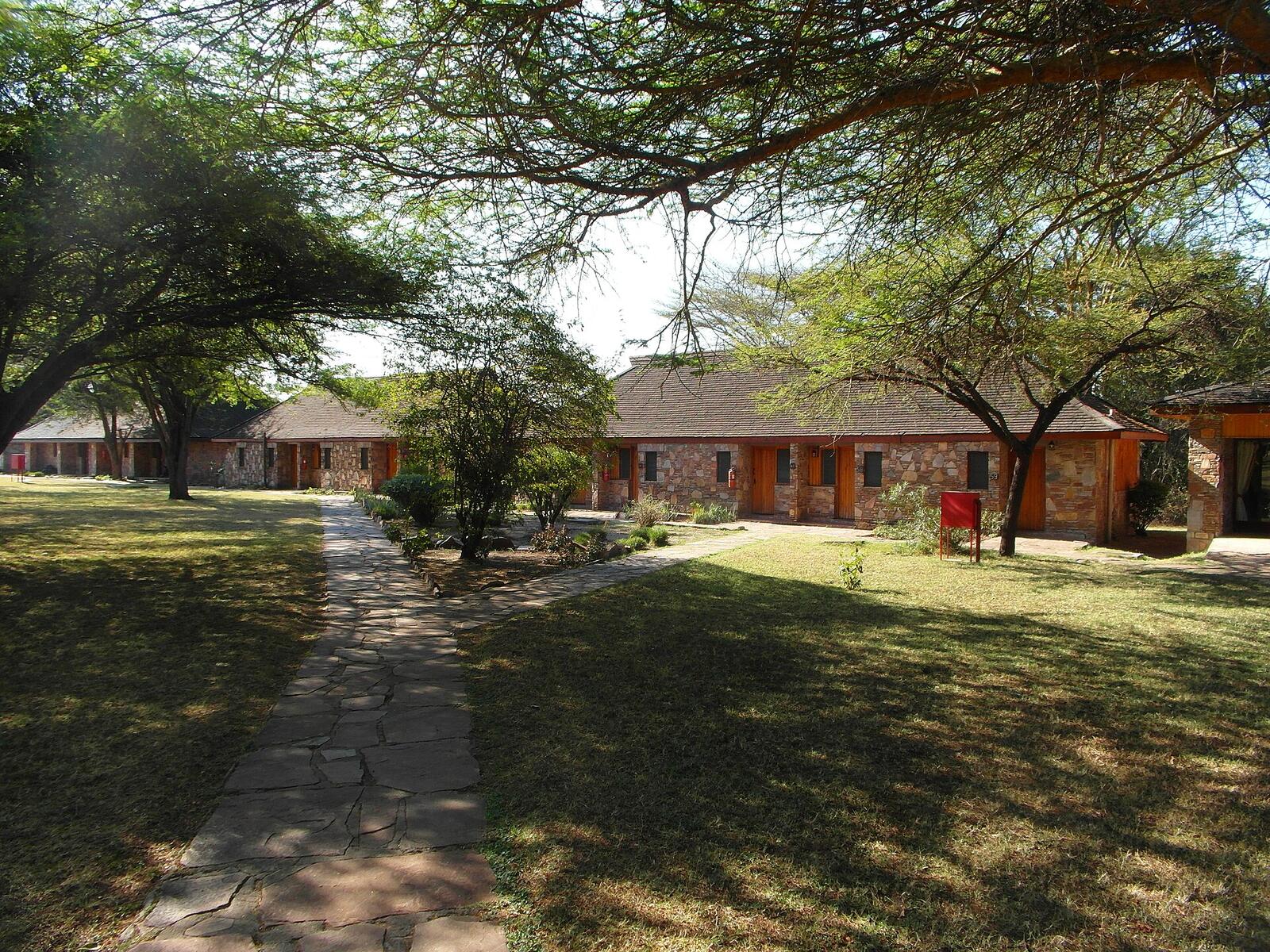 Illustrative accommodation photography for a fictional kenya stay — illustrative style for Chyulu Horizon Lodge