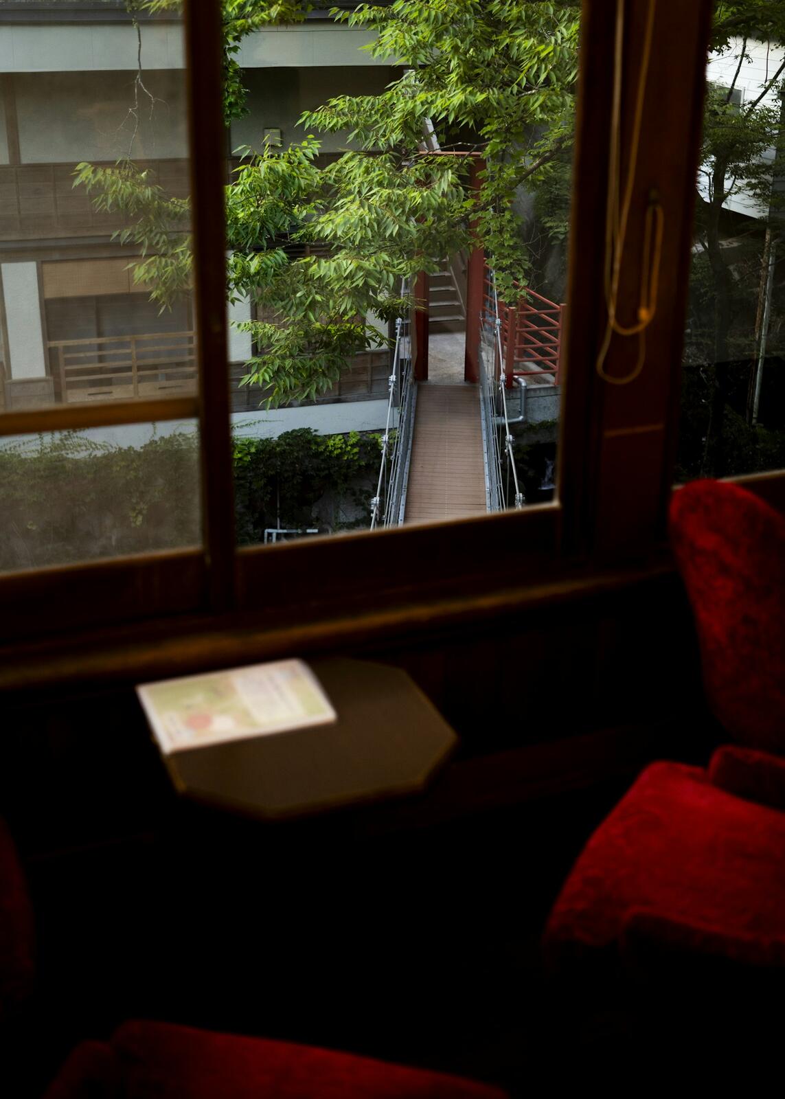 A room with a red chair and a window — illustrative property style — illustrative style for Tokyo Lantern House
