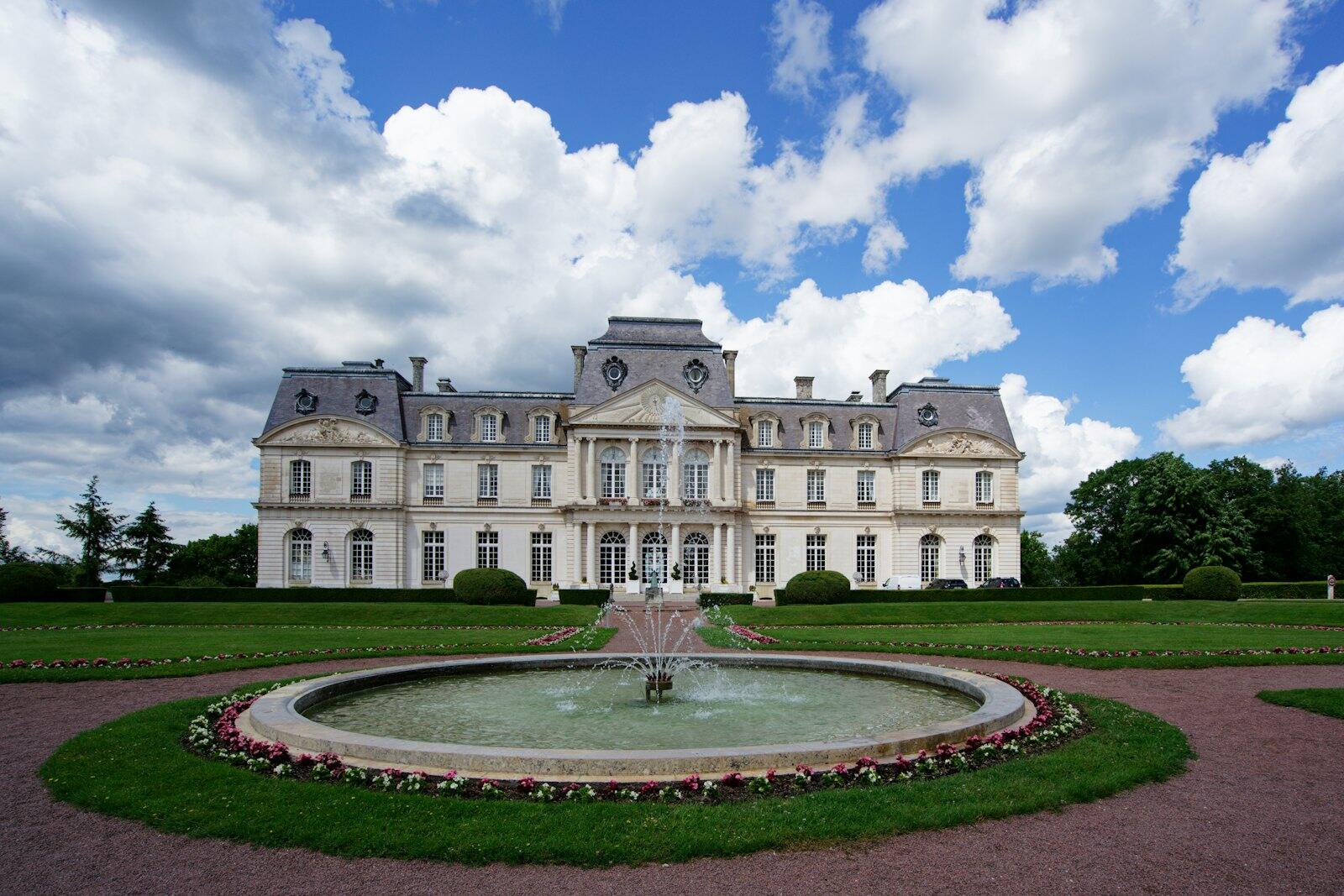 a large building with a fountain in front of it — illustrative property style — illustrative style for Riviera Garden Residence
