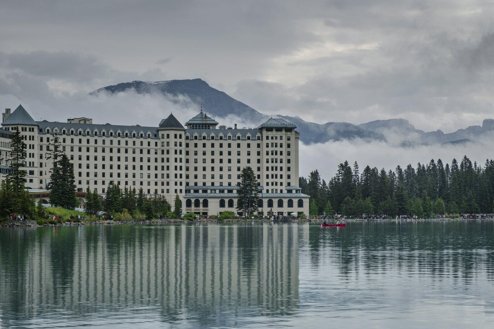 Grand hotel on a lake with mountains behind — illustrative property style — illustrative style for Victoria Garden Court