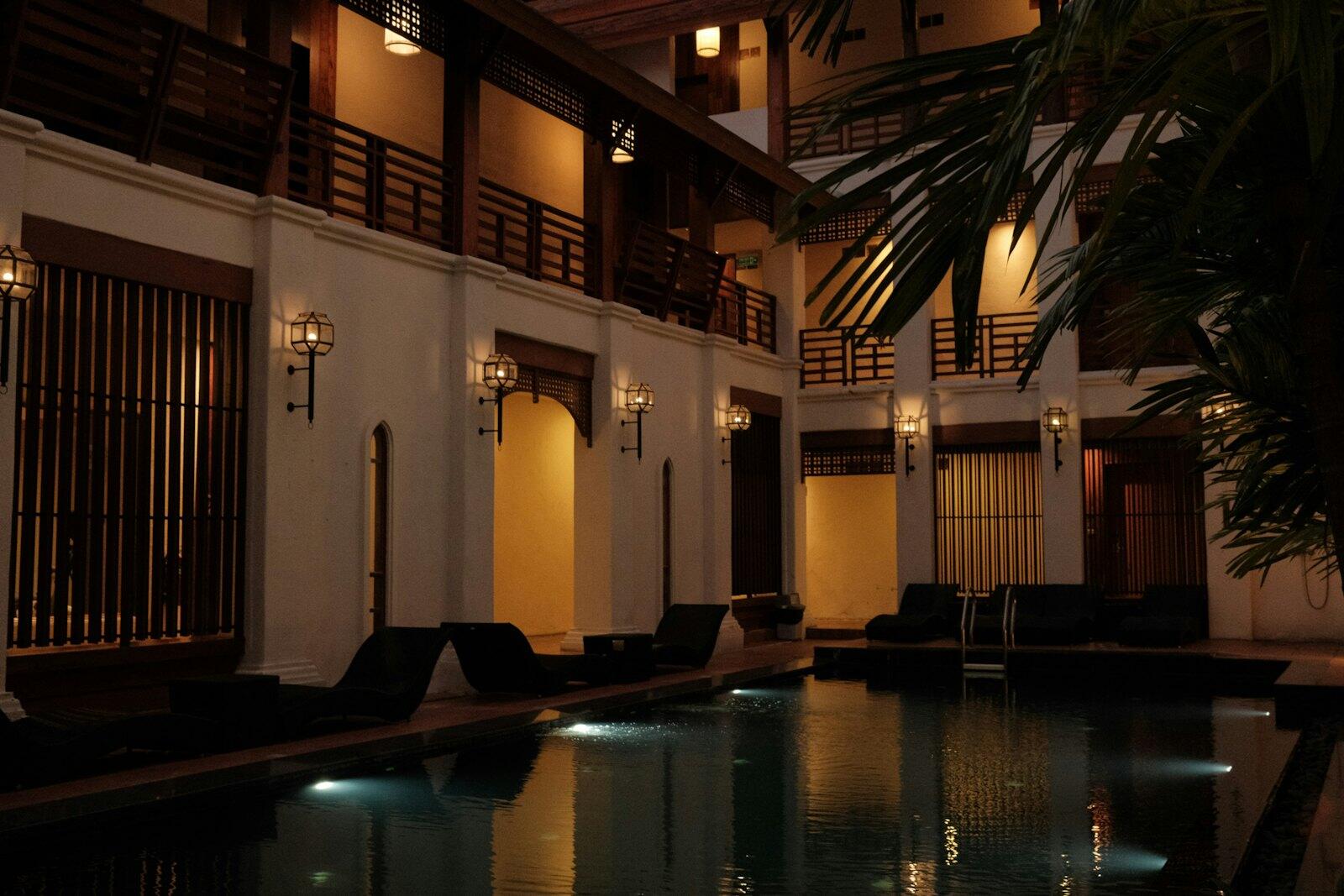 A pool in a hotel with lights on at night — illustrative property style — illustrative style for Krabi Family Cove