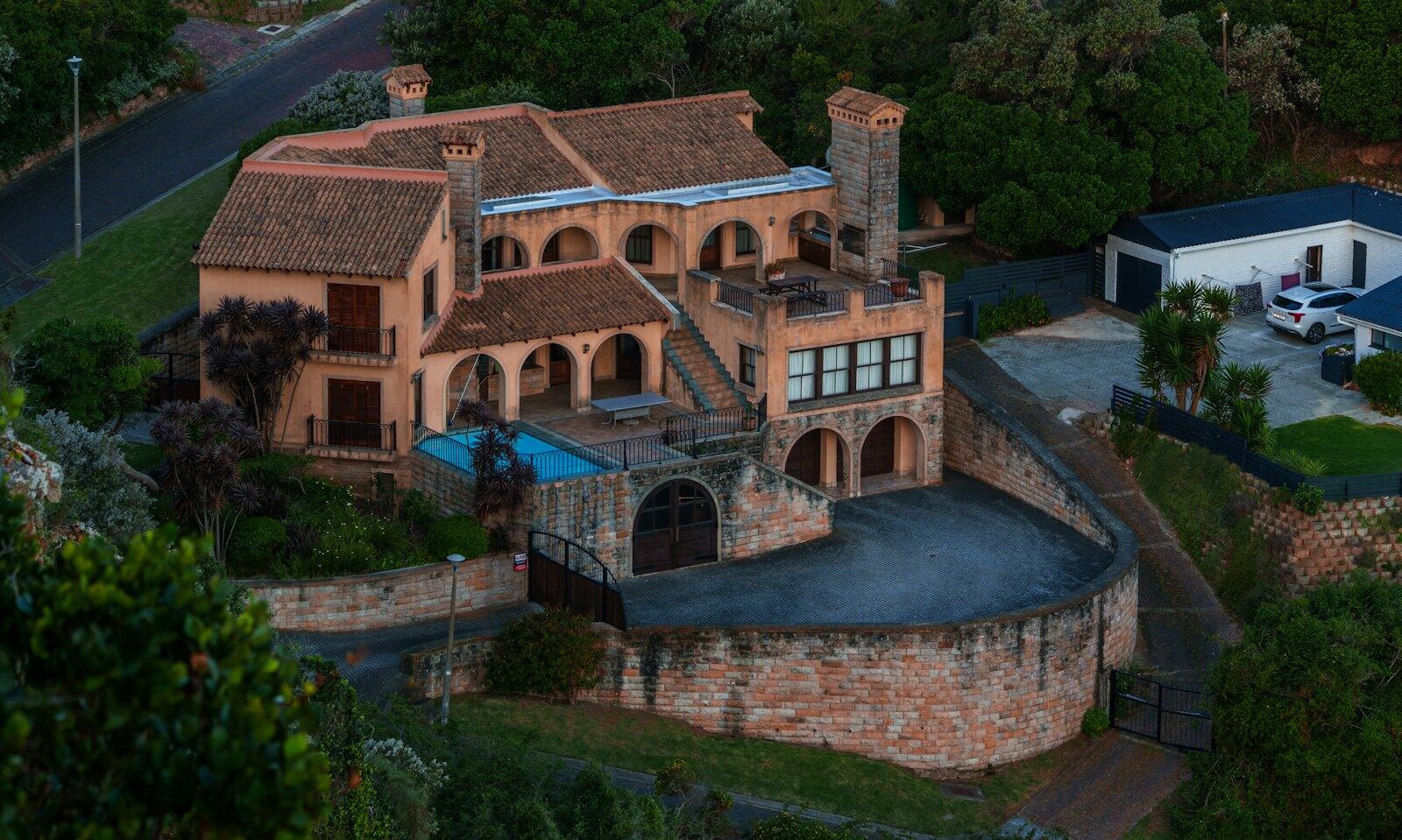 Castle-like mansion with a pool and courtyard — illustrative property style — illustrative style for Eastern Cape Family Lodge