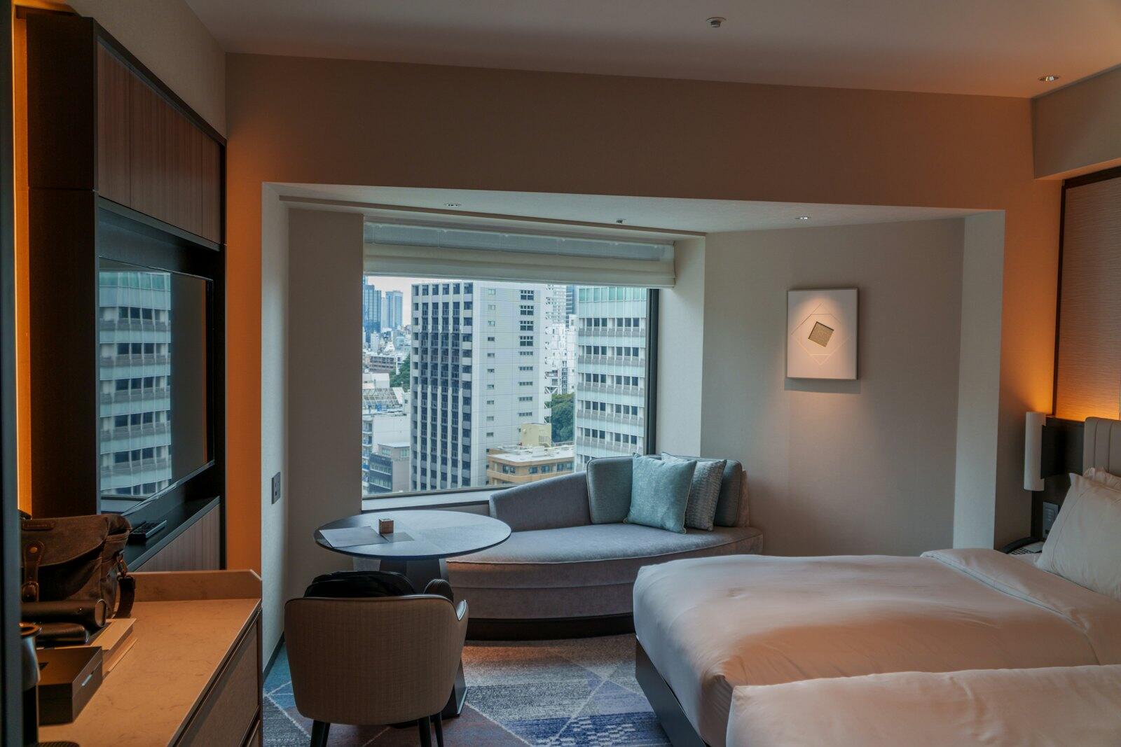 A hotel room with two beds and a couch — illustrative property style — illustrative style for Kyoto Garden Court