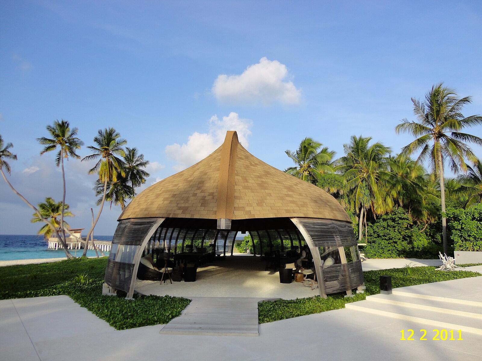 Illustrative accommodation photography for a fictional maldives stay — illustrative style for Sunstone Sandbank House